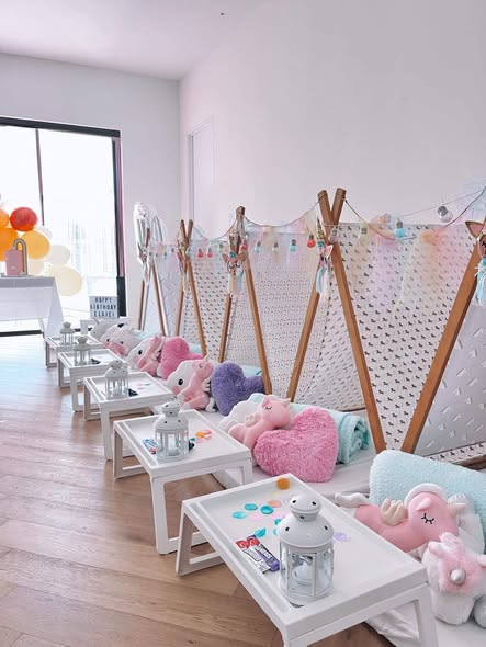 Pastel teepee sleepover setup with plush toys and birthday balloons