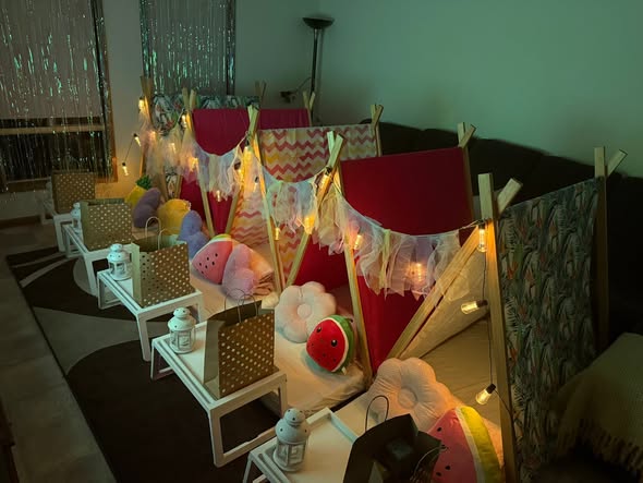 Tropicana themed teepees glowing with fairy lights and fruit cushions