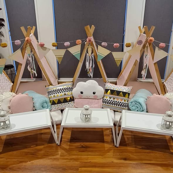 Pastel teepees with cloud cushion, bunting and paper lanterns